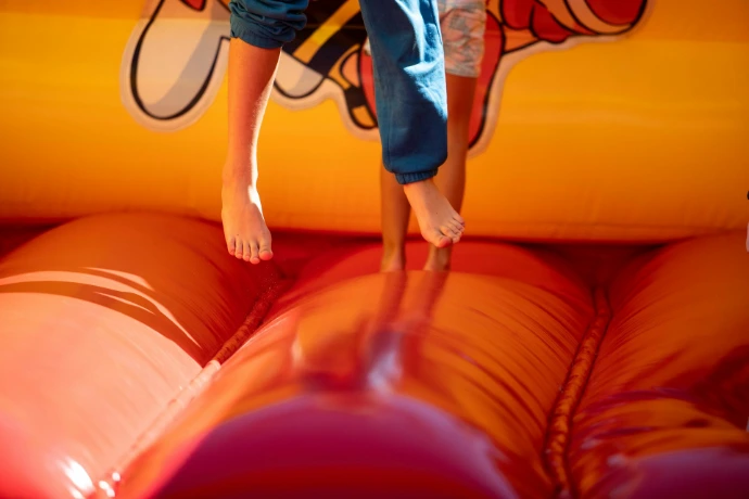 A young boy jumping on a bouncy castle
